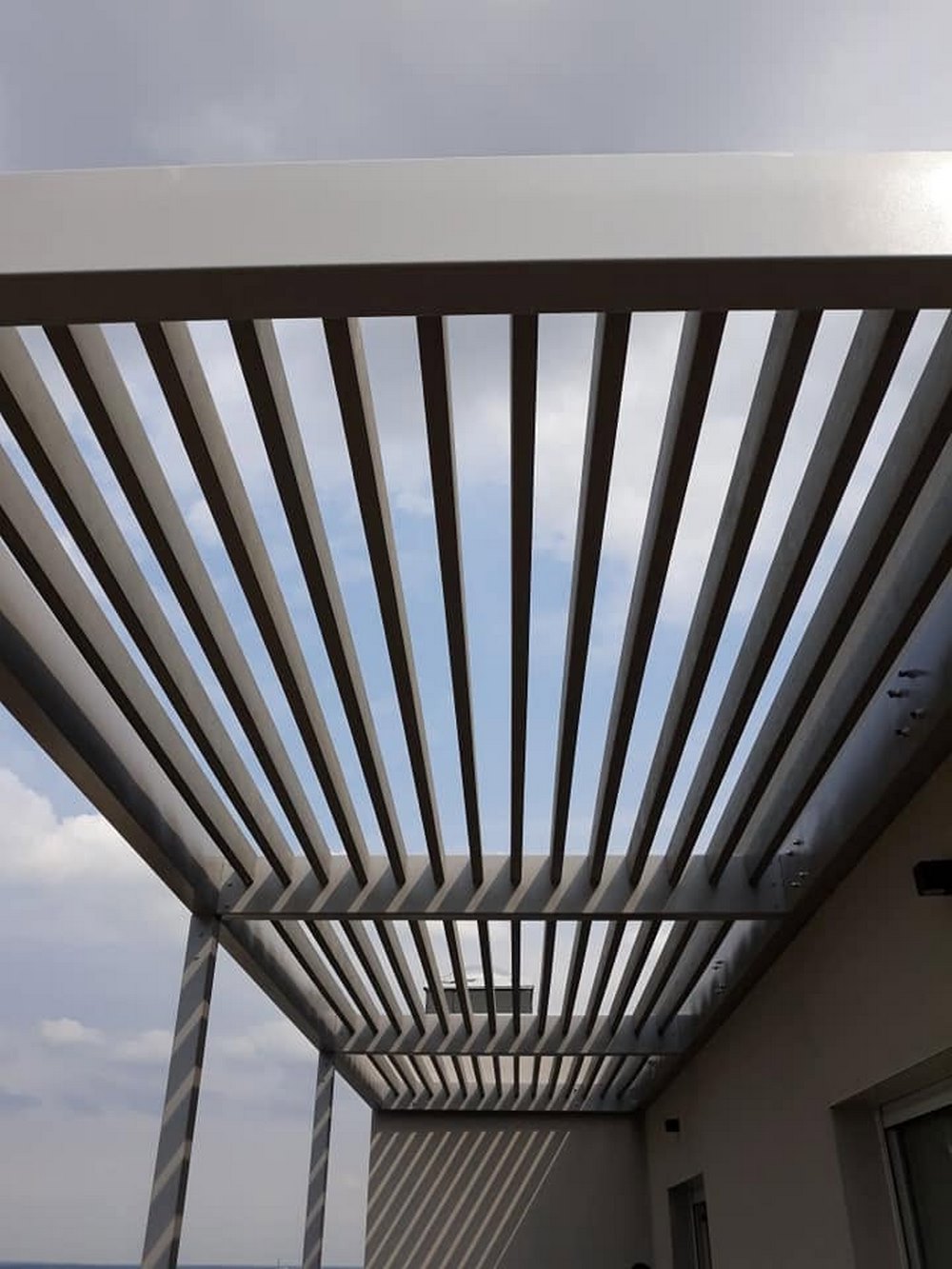 Drewniana pergola ogrodowa tworząca zadaszoną strefę wypoczynku