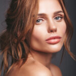beauty fashion portrait of young blond woman model with natural makeup and perfect skin posing in studio